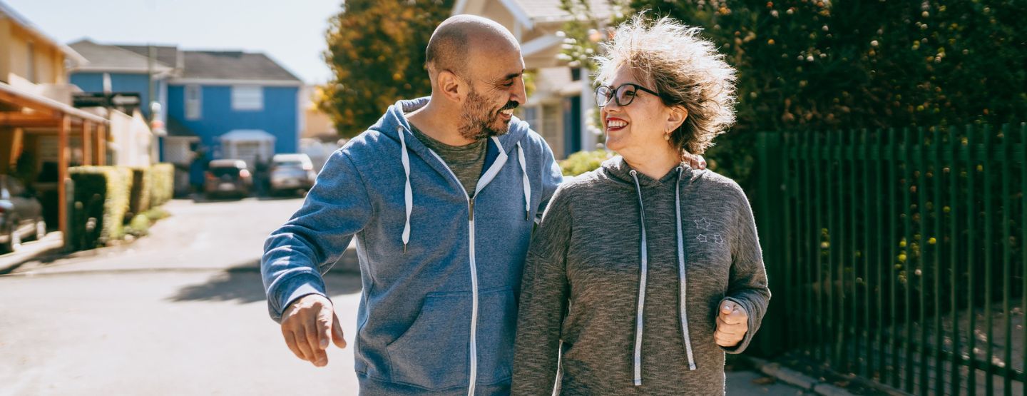 Couple walking together through neighborhood.