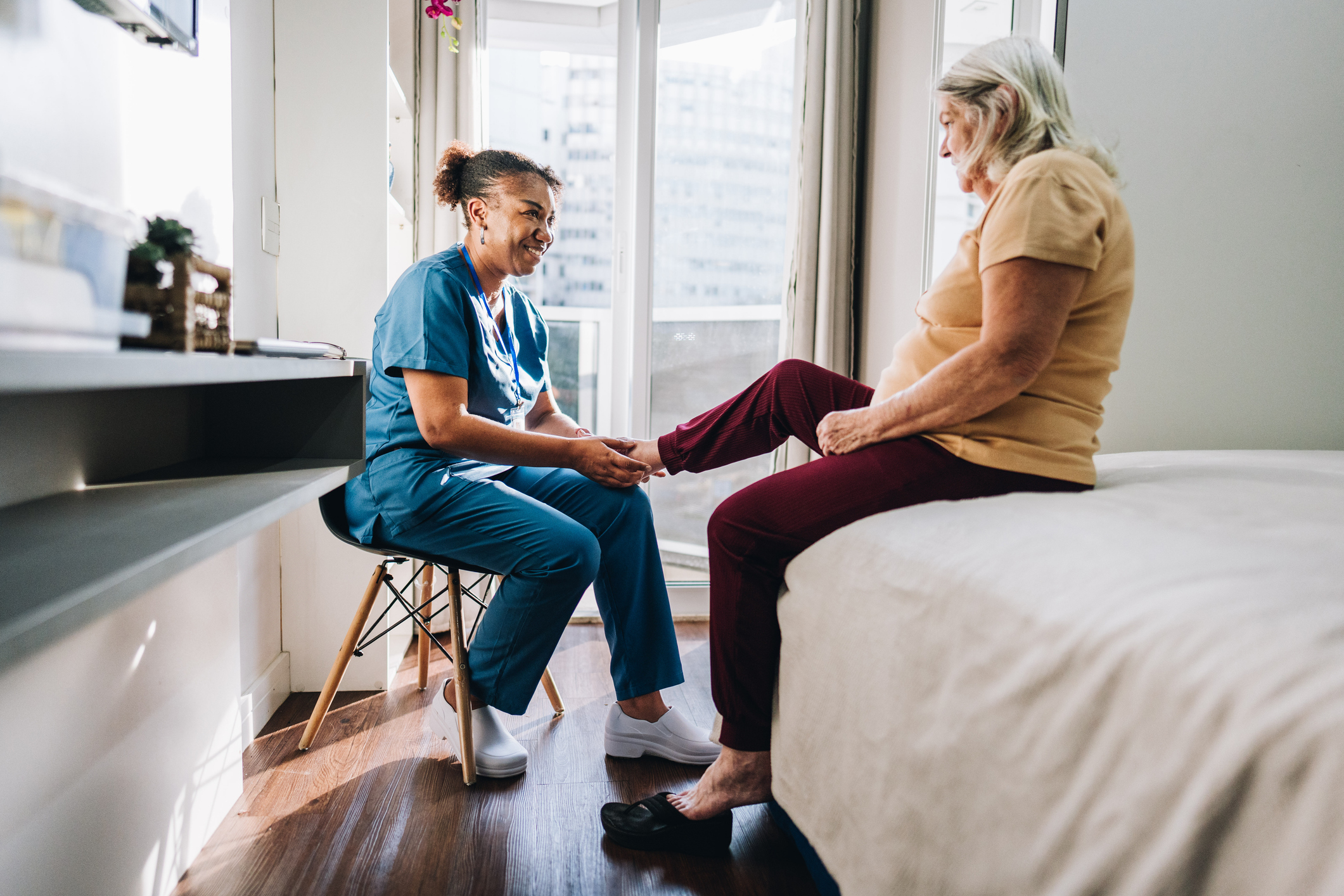 Woman caring for patient's foot stock image