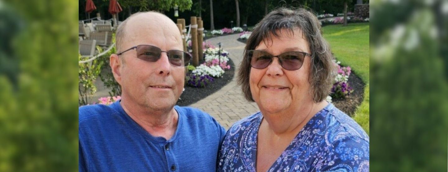 Bob and Susie Zimmerman smiling outside.