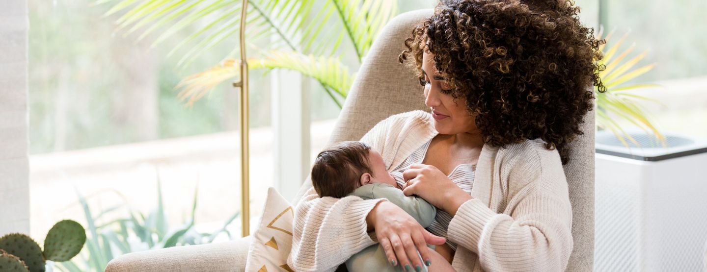 Mom breastfeeds newborn baby 