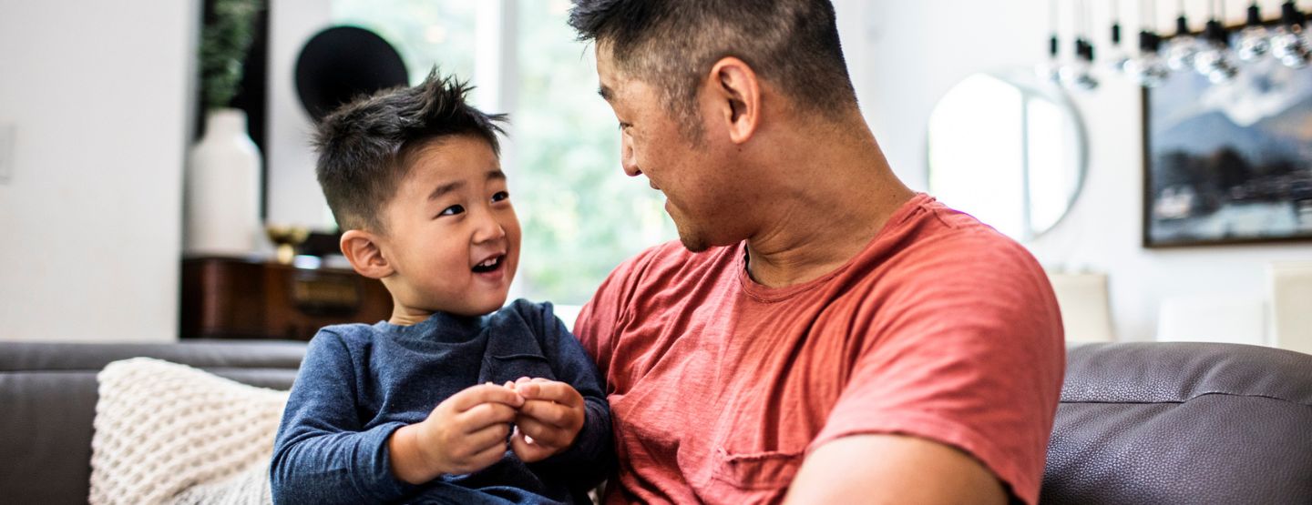 Father talking with son at home