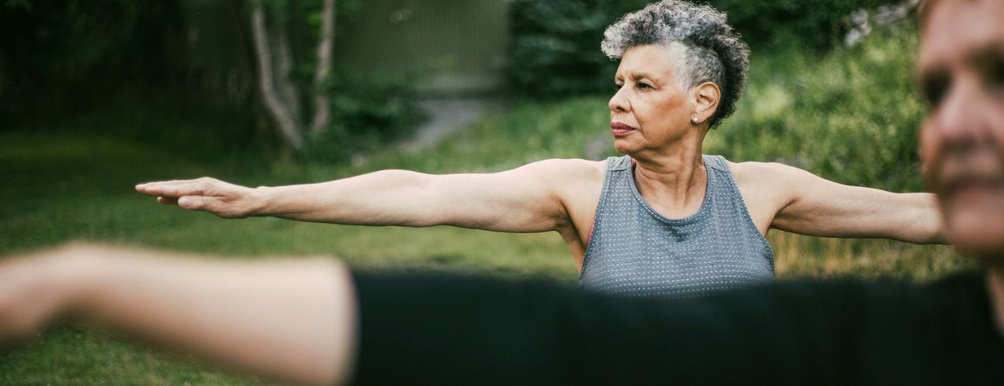 Mature woman doing yoga outside.