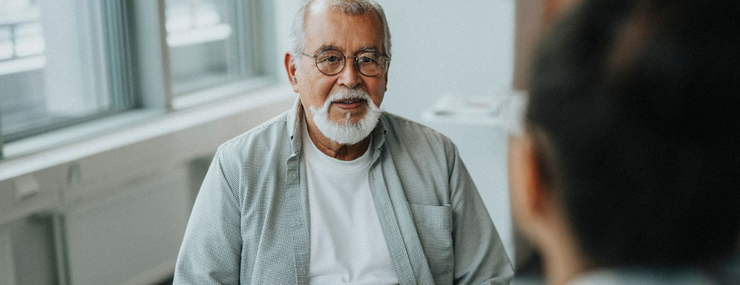 Mature man speaking with provider. 