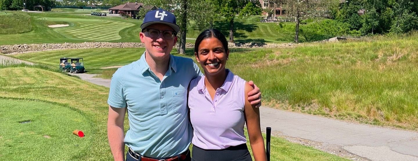 Dr. Ambati with husband on golf course. 