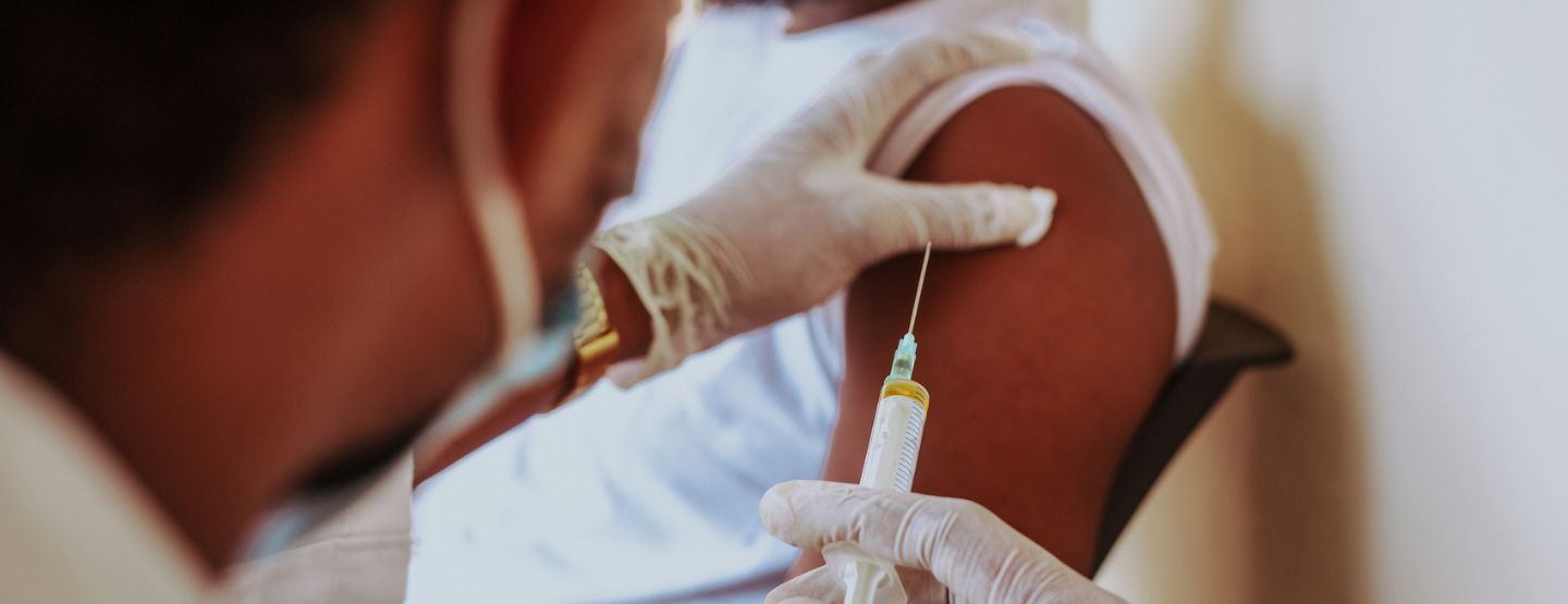 Practitioner administering a flu vaccine. 