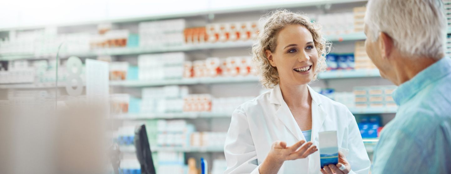 Pharmacist explaining medication to mature patient. 