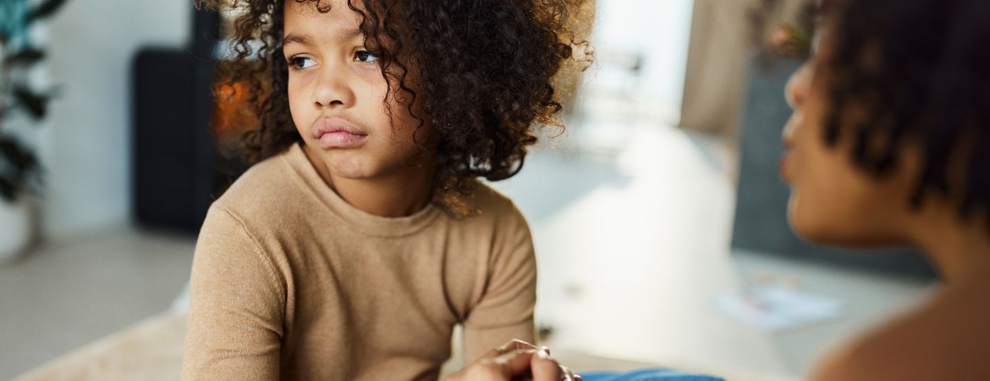 Mother talking to child about difficult topic.