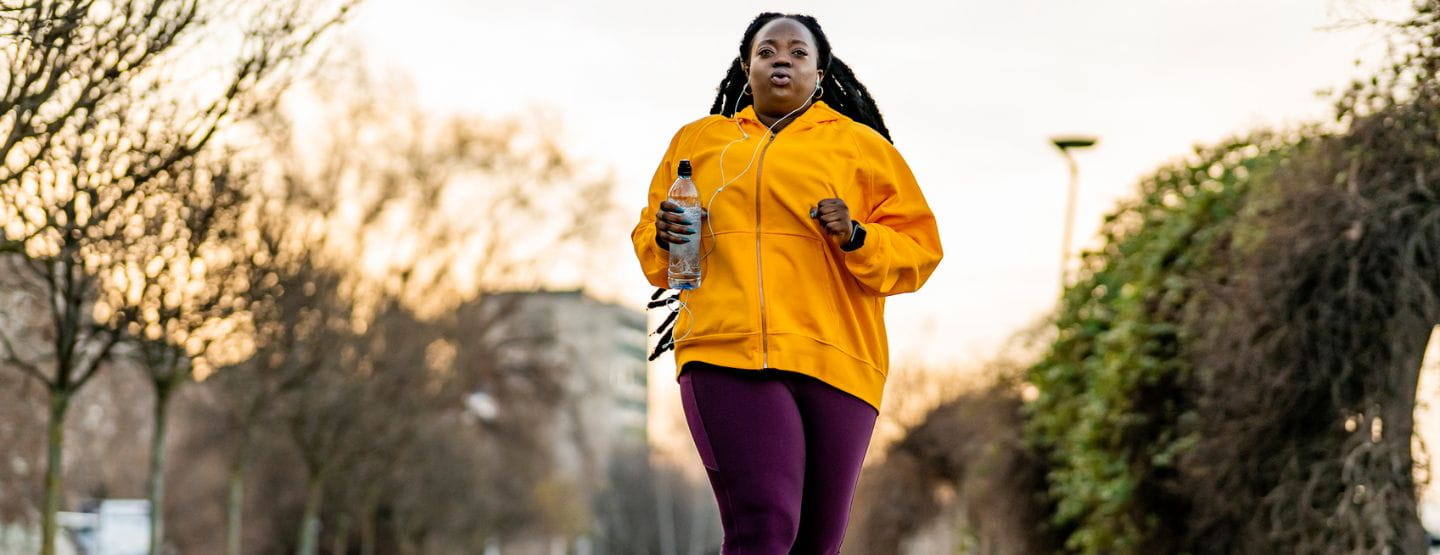 Plus size woman running in the park.