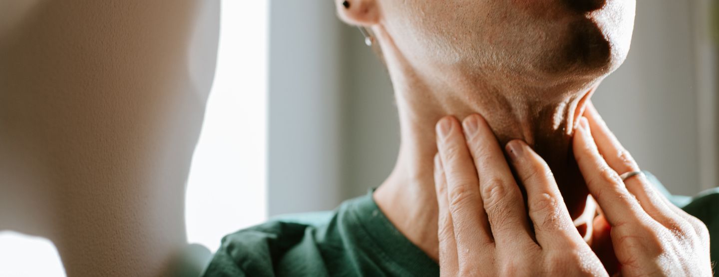 Man feels swollen lymph nodes on neck. 