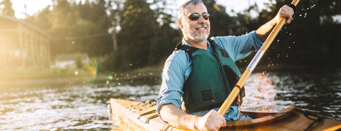Mature adult kayaking in the sun.