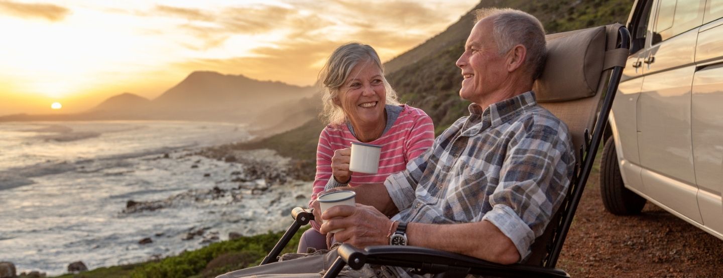 Senior couple enjoying sunset by the sea