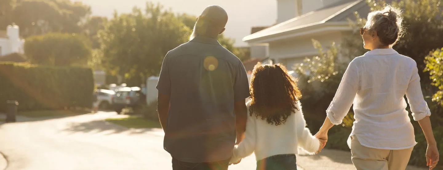 Family taking an evening walk in the neighborhood.