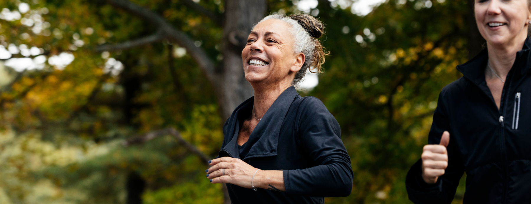 Middle-aged woman running with friend.