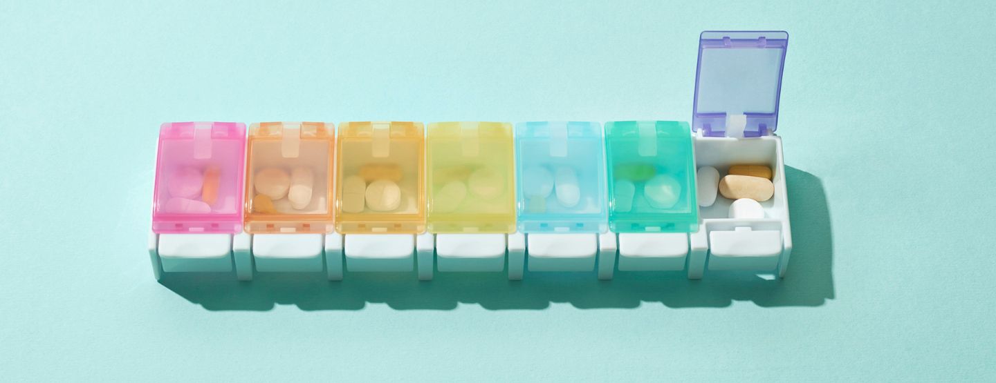 Colorful weekly pill box organized with medication for the week. 