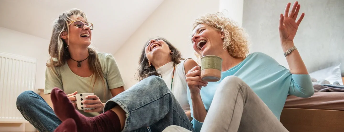 Middle aged women laughing together.