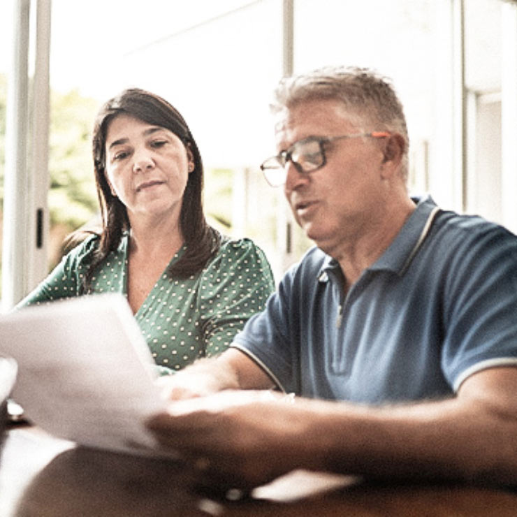 A mature couple research financial support options for cancer treatment