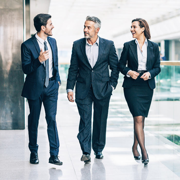 Three ProMedica executives walk and discuss the companies various government relationships