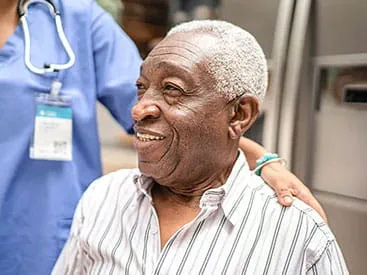Caregiver embracing patient