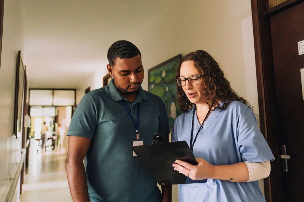 a nurse gives instructions to a hospital volunteer