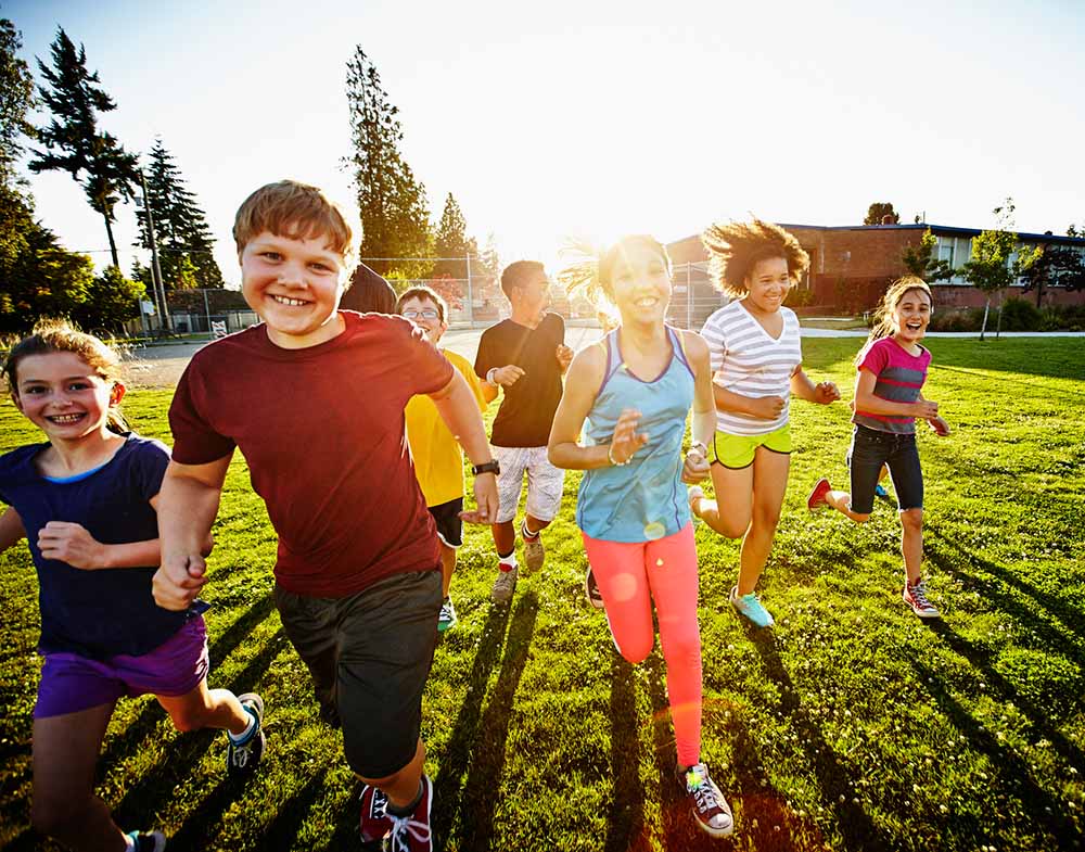 a group of children run 