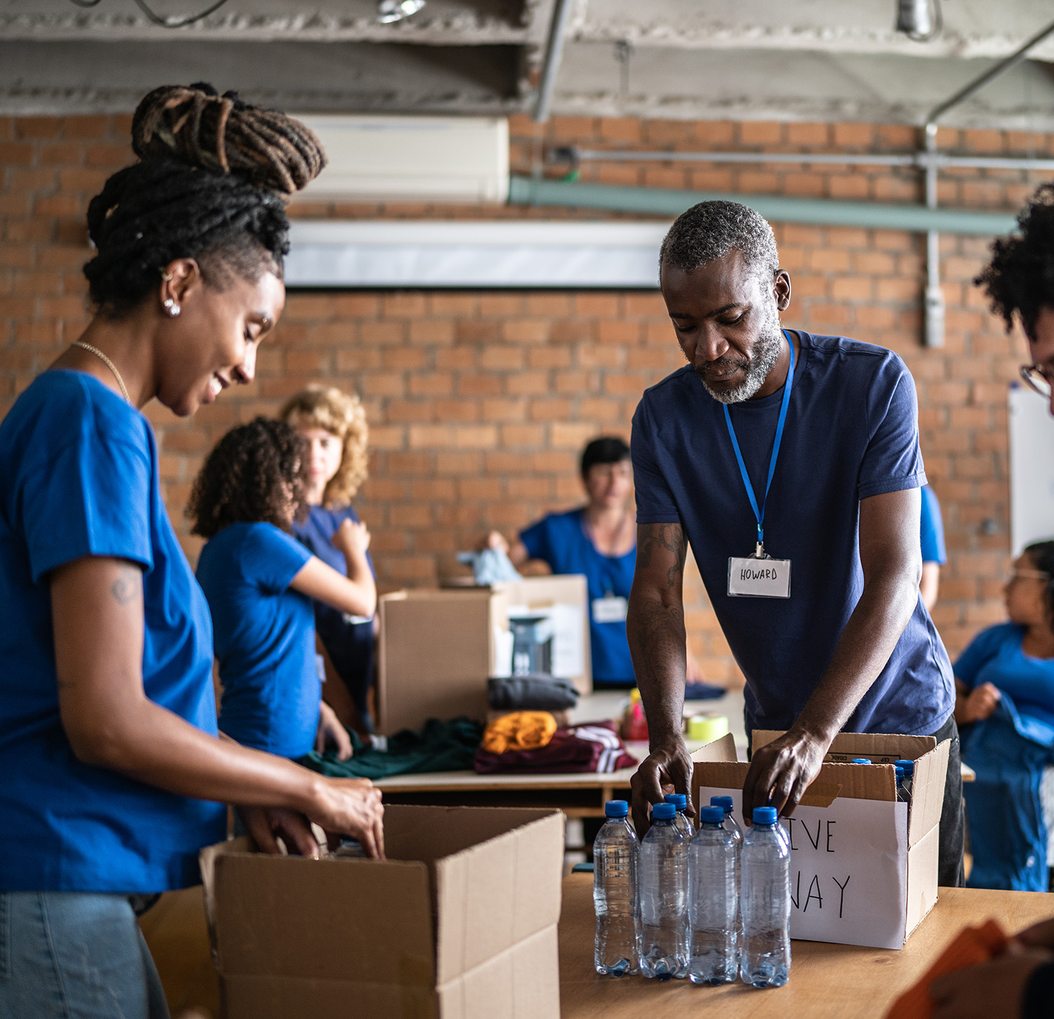 People helping pack boxes 