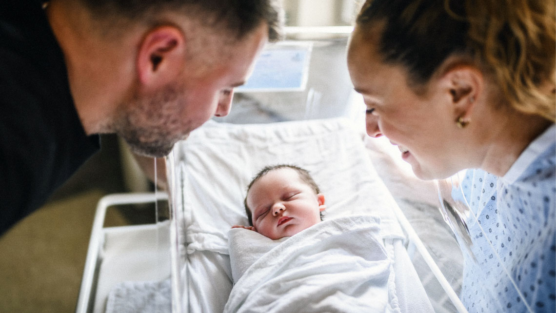 parents look at their newborn child