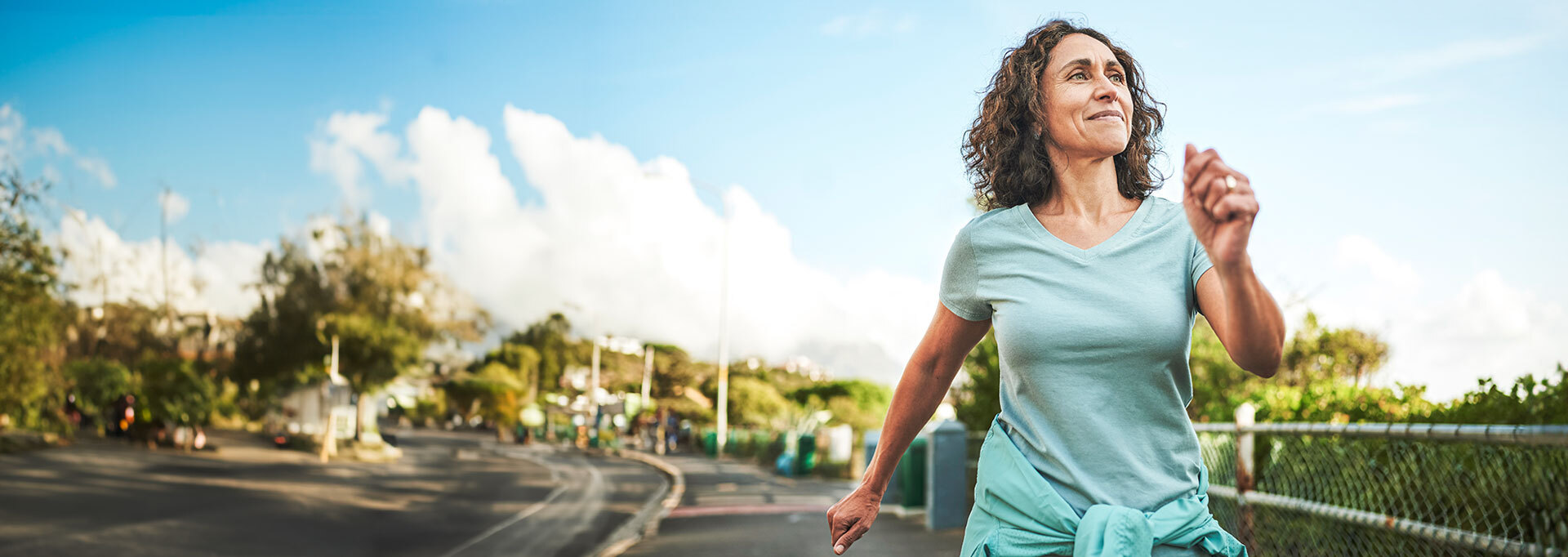 Woman jogging on suburban road