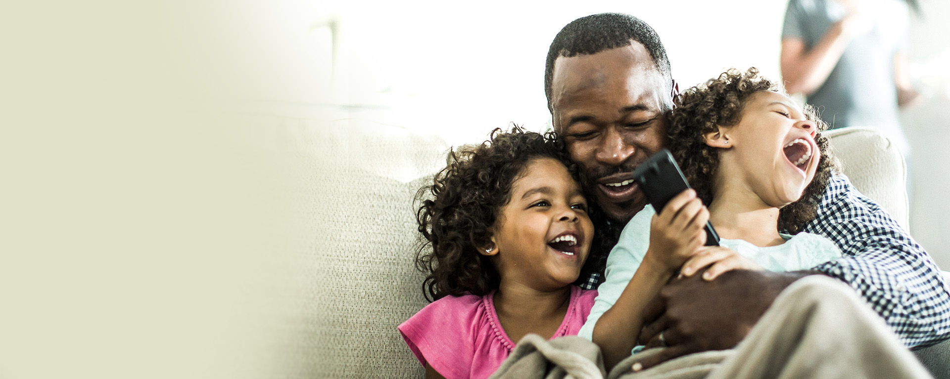 dad with 2 girls laughing