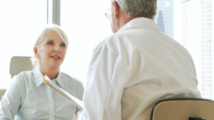 one woman talking to a man in a white coat