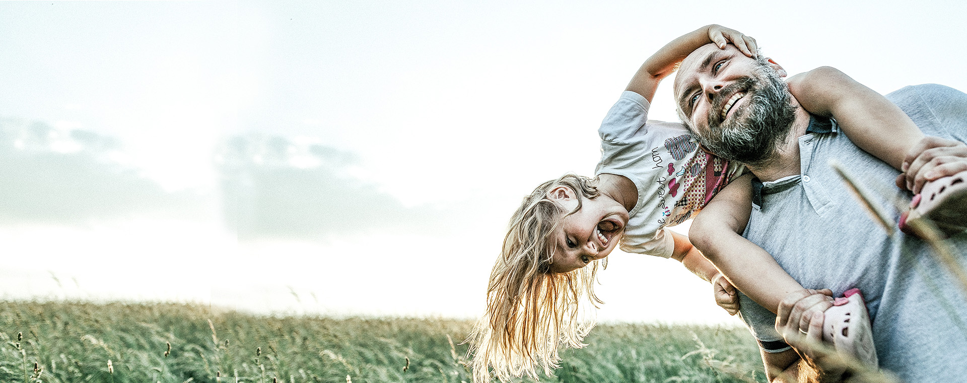 Man with Daughter on shoulders smiling 