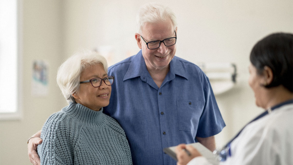 a mature couple discusses heart health with their doctor