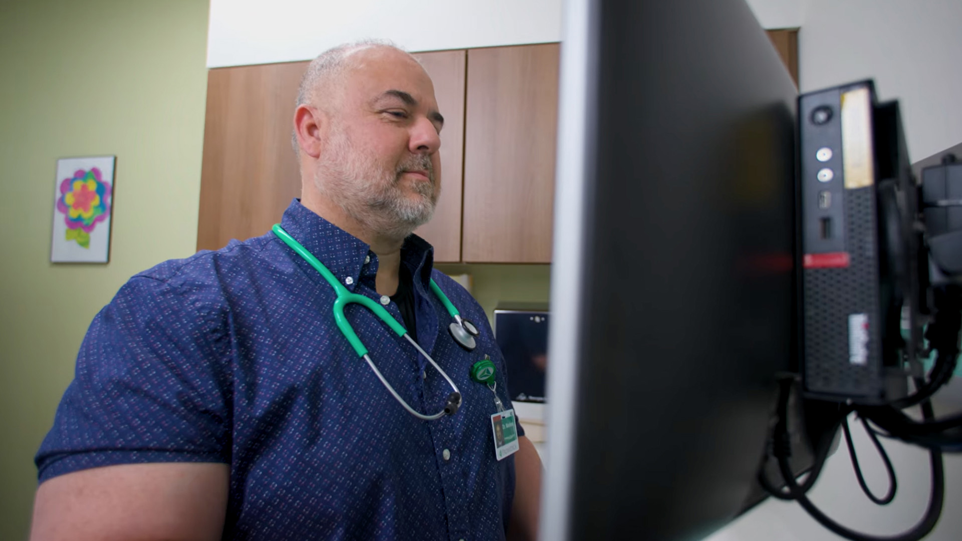 man who is a healthcare worker at a computer 