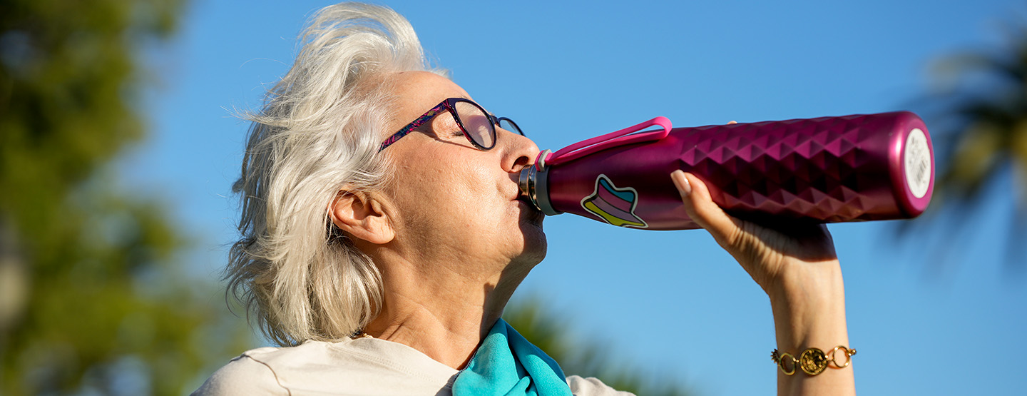 Woman drinks from water bottle