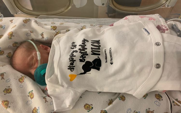 An above shot of a newborn in the NICU