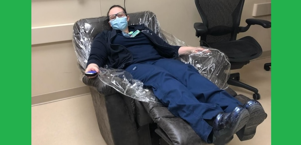 A healthcare worker lounges in a newly donated La-Z-Boy chair