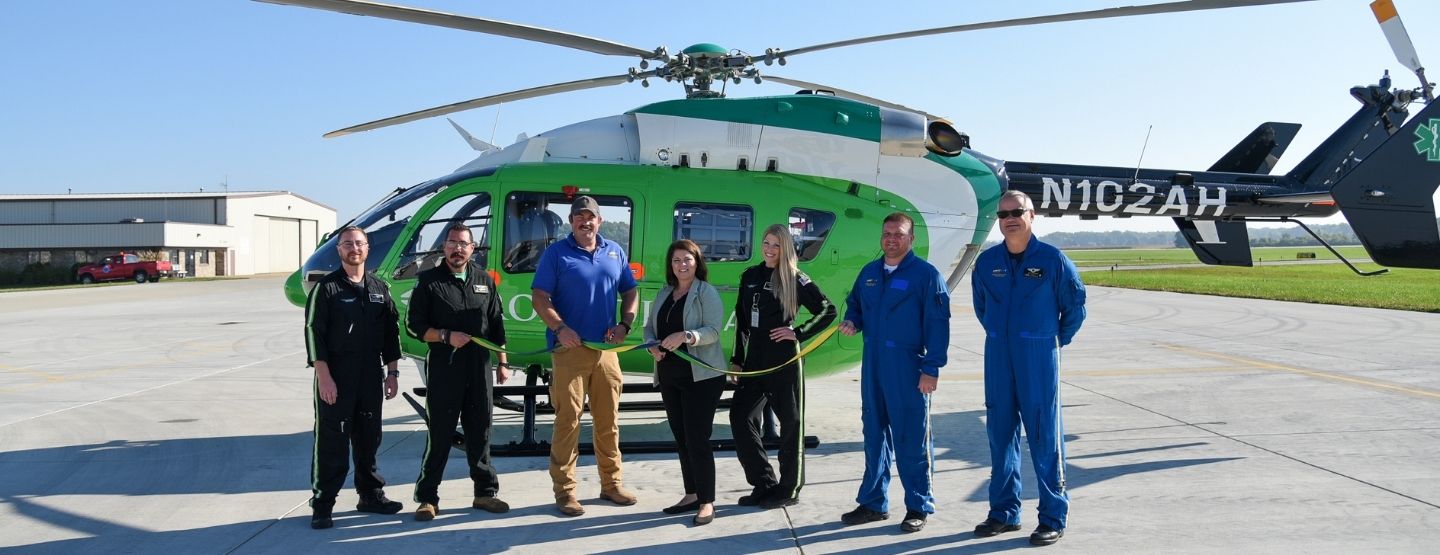 ProMedica Air and Mobile team stands in front of new helicopter. 