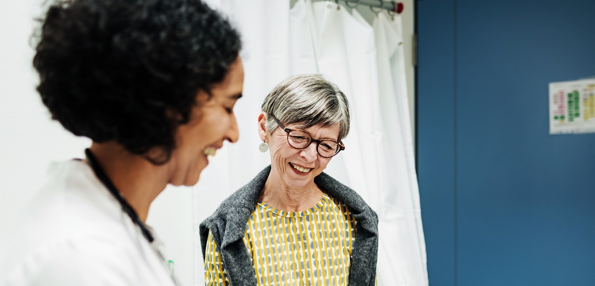 A female physician is meeting with a senior female patient.