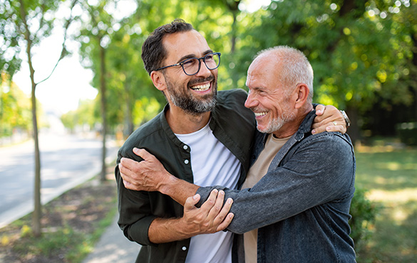 father and son hugging in park