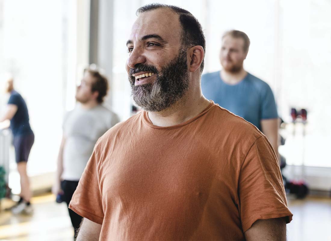 a mature man takes part in an exercise class