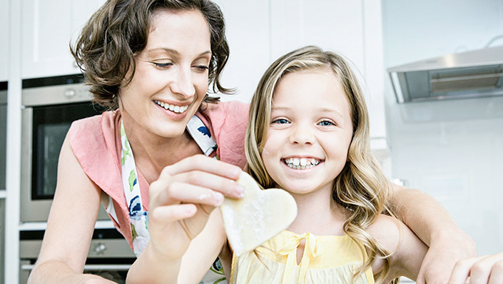 A mother and daughter make homemade cookies in the kitchen